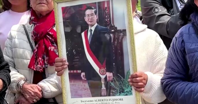 People hold photo of former Peruvian President Alberto Fujimori