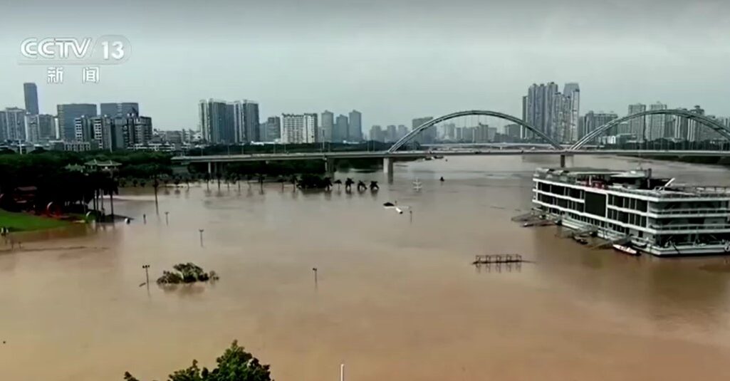 Aerial views of ship and bridge over flooded river