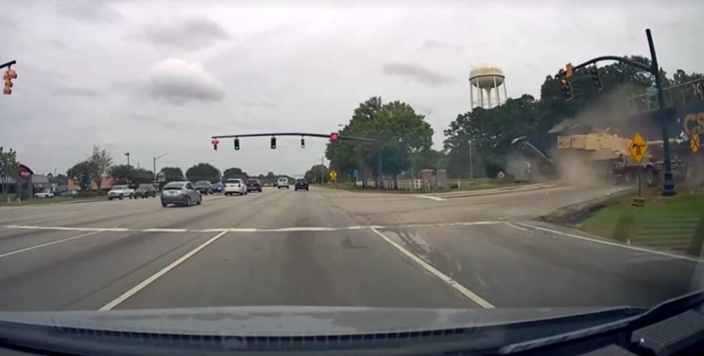 freight train collides with semi-truck hauling military tank