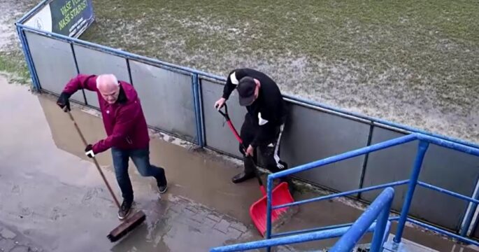 Personnel cleaning soccer stadium after flood in Czech