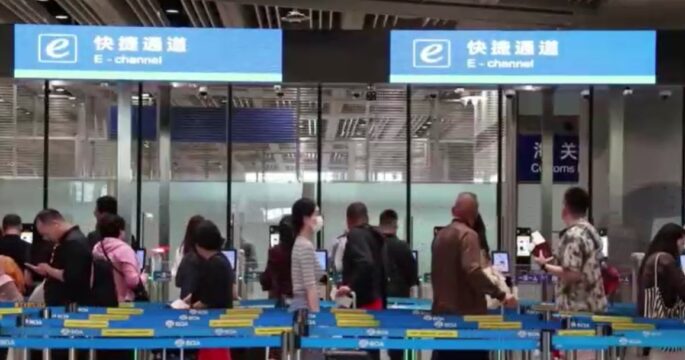 travelers wait at China's airport e-channels