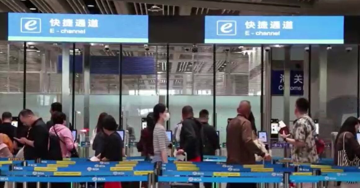 travelers wait at China's airport e-channels