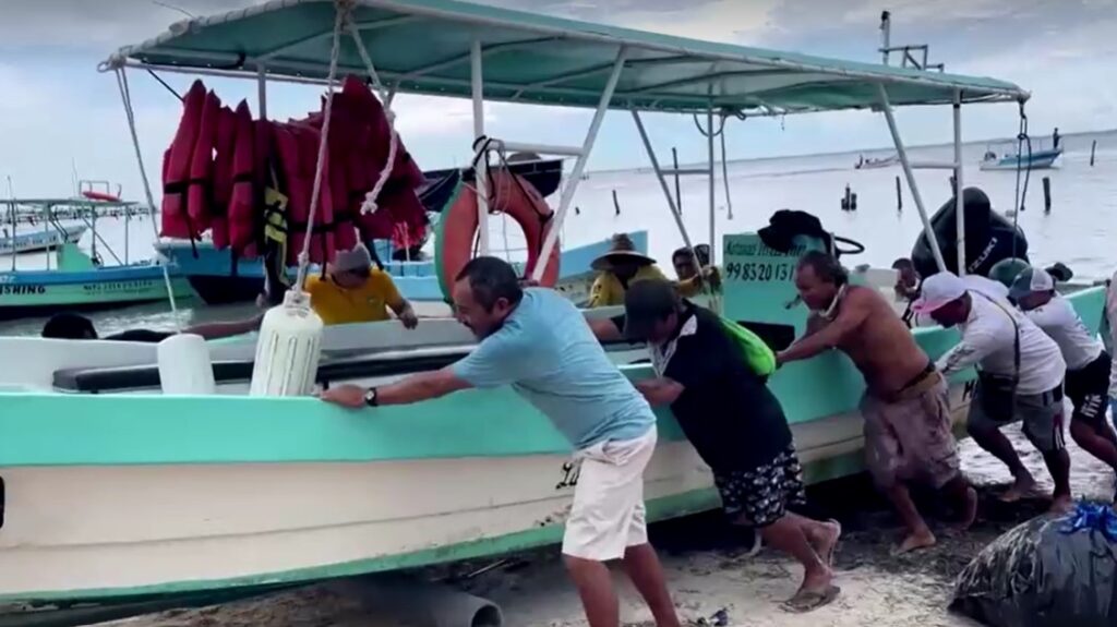 fishermen in Cancun secure their boats before hurricane arrive