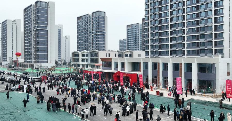 people waiting in front of buildings in China