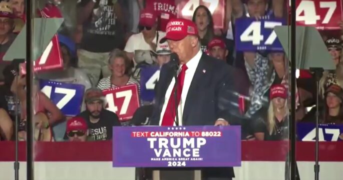 Donald Trump in campaign with a protect shield