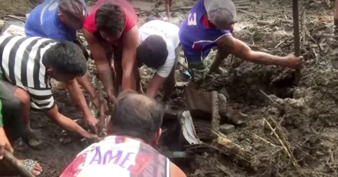 Residents and rescue workers in Philippines dug through mud and rubble to remove bodies from a landslide