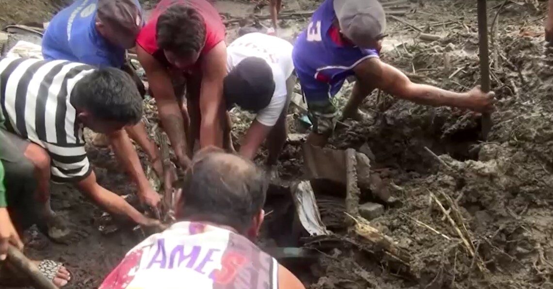 Residents and rescue workers in Philippines dug through mud and rubble to remove bodies from a landslide