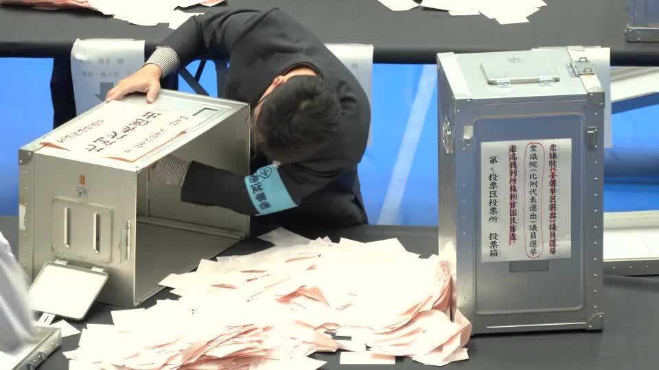 Japan election officer gathers voting ballot