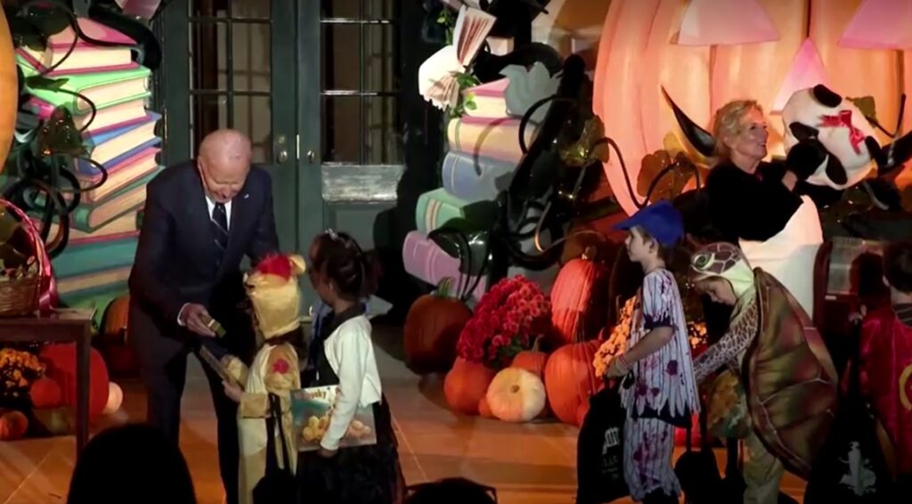 President Biden and First Lady, in panda costume, welcome Halloween trick-or-treaters