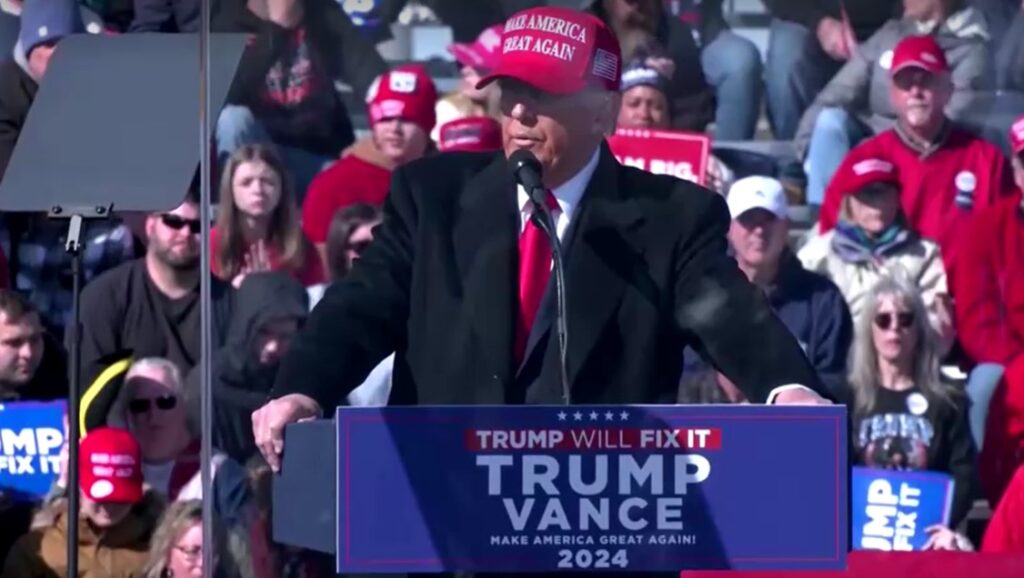 Donald Trump wearing red cap at campaign rally in Pennsylvania