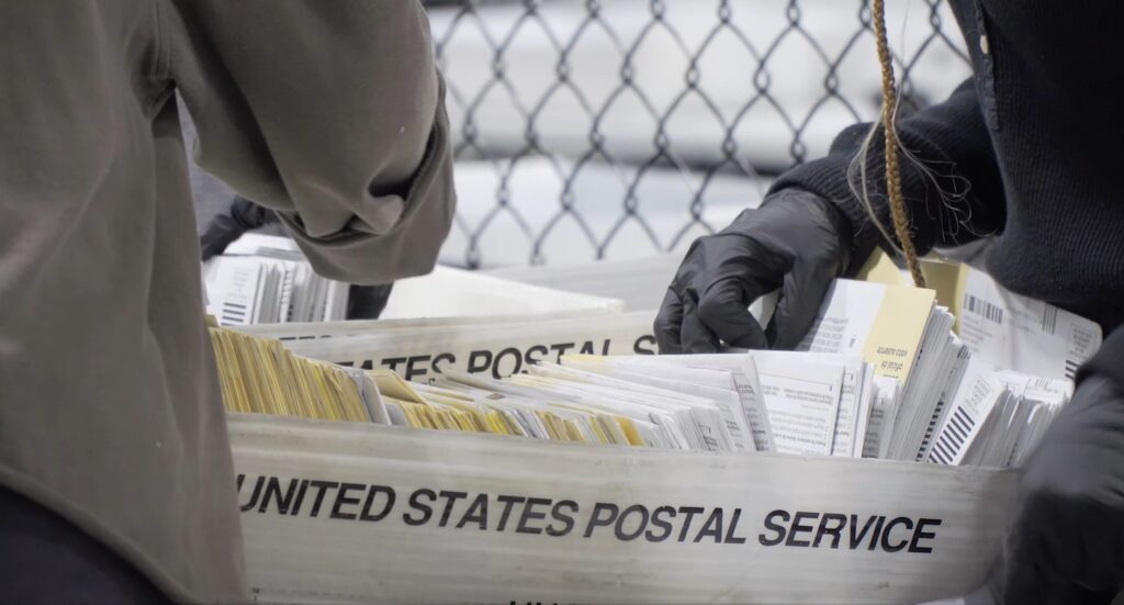 workers count early voting ballots sent via mail