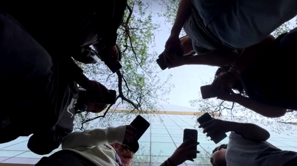 teens using smartphone from ground view