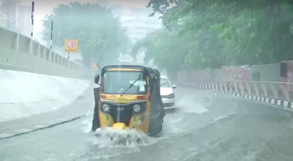 vehicles move through flood in Chennai