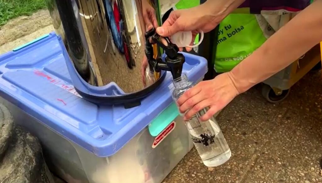 resident in Santiago bottles up water