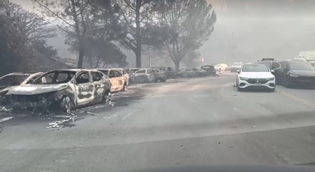 burned cars alongside of road in Pacific Palisades