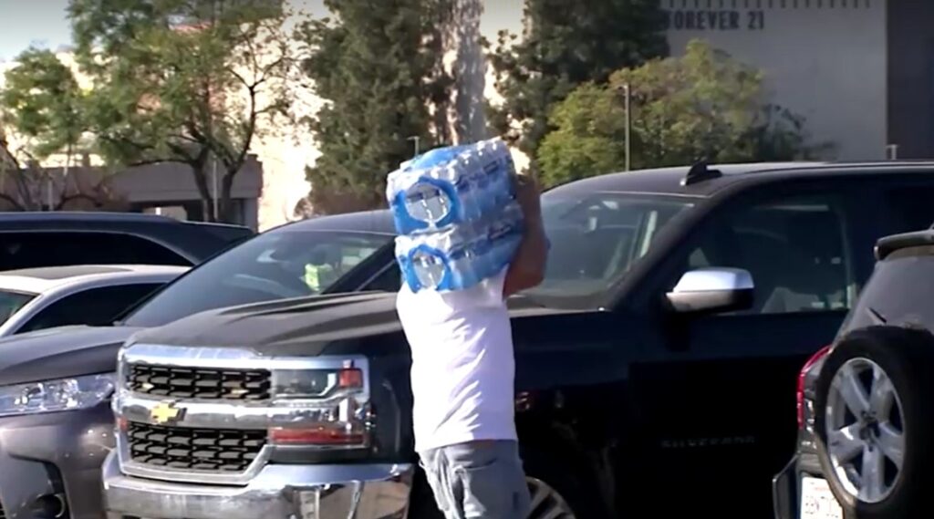 LA wildfire victim carries donated bottles of water