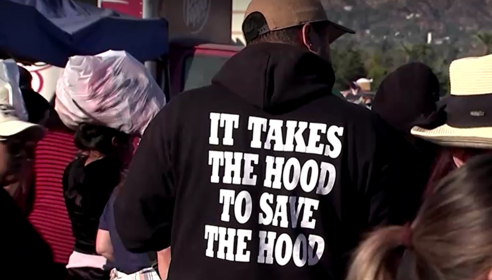 man wear shirt says It takes the hood to save the hood