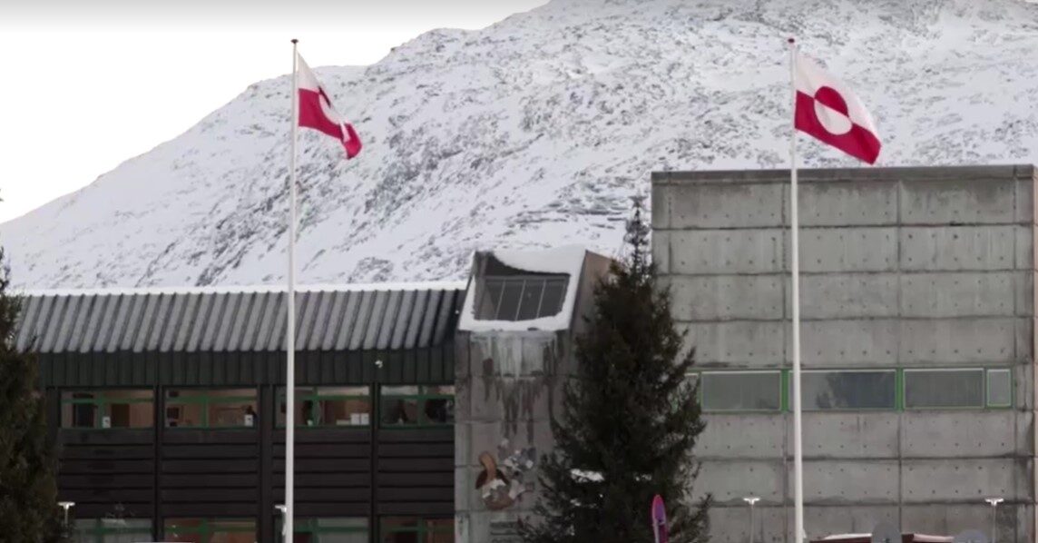 Greenland flags with snowy mountain as background