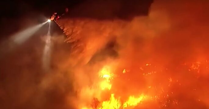 helicopter dousing wildfire in LA