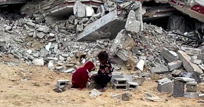 children play among debris in Gaza