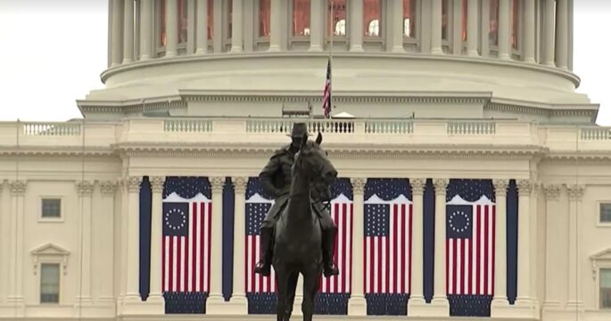 exterior of U.S. Capitol decorated with U.S. flags