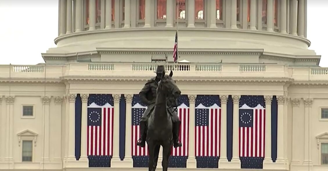 exterior of U.S. Capitol decorated with U.S. flags