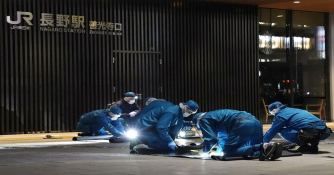 Police officers investigate the site of a random stabbing incident near JR Nagano Station