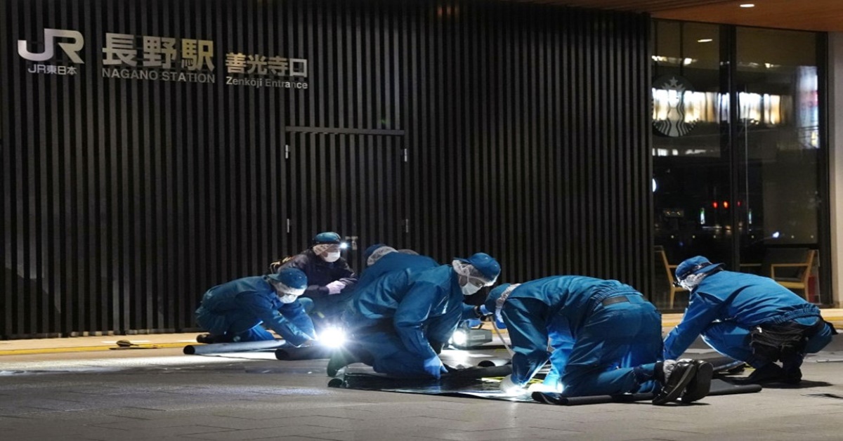 Police officers investigate the site of a random stabbing incident near JR Nagano Station