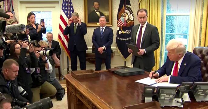 Trump signs executive order among reporters in Oval Office