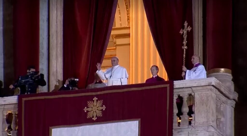 Newly elected Pope Francis arriving on balcony of St. Peter's basilica and greeting crowds on March 13,2013