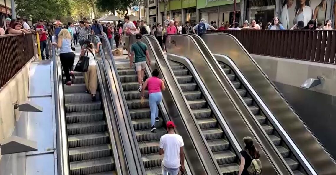 Metro users stepping up automatic escalators in Santiago, Chile