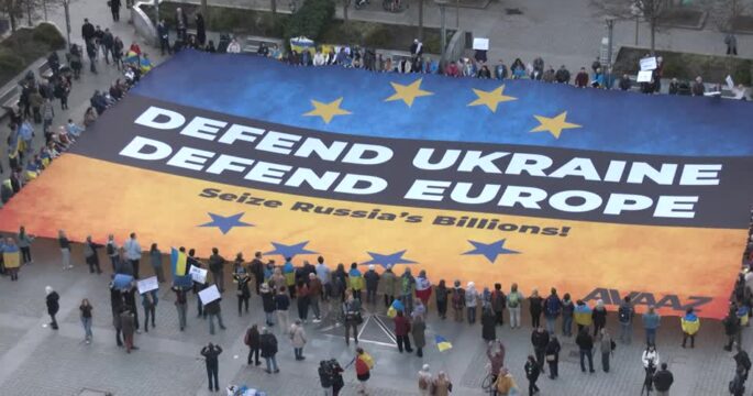 Massive Ukrainian flag unfurled in Brussels to urge seizing of frozen Russian assets