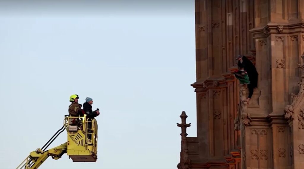 Rescuers on crane talk with protester climbs London's Big Ben with Palestinian flag