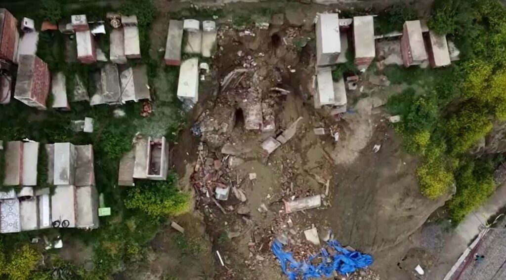 Aerial shot of Bolivians exhume loved ones from cemetery that collapsed after intense rains