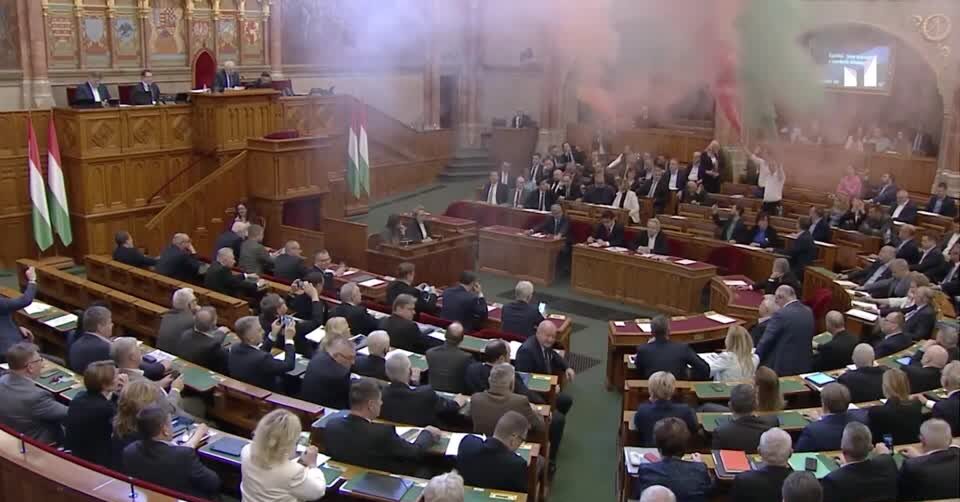 Opposition MPs light up flares as Hungarian parliament passes law to ban Pride march