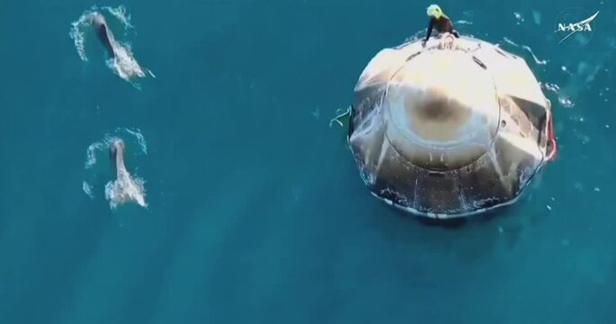 Dolphins swim around SpaceX capsule after splashdown from the ISS