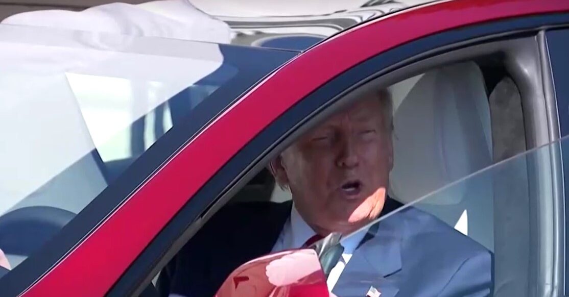 Trump sits in a car