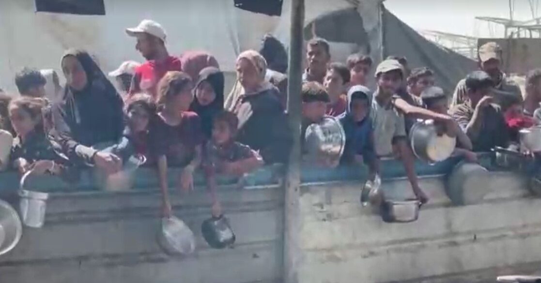displaced people in Gaza wait for food