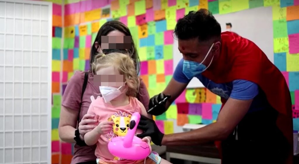 girl being vaccinated in U.S. blurred