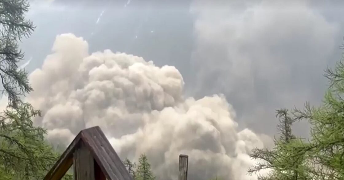Glacier partially collapsed, creating a huge cloud towards Swiss village