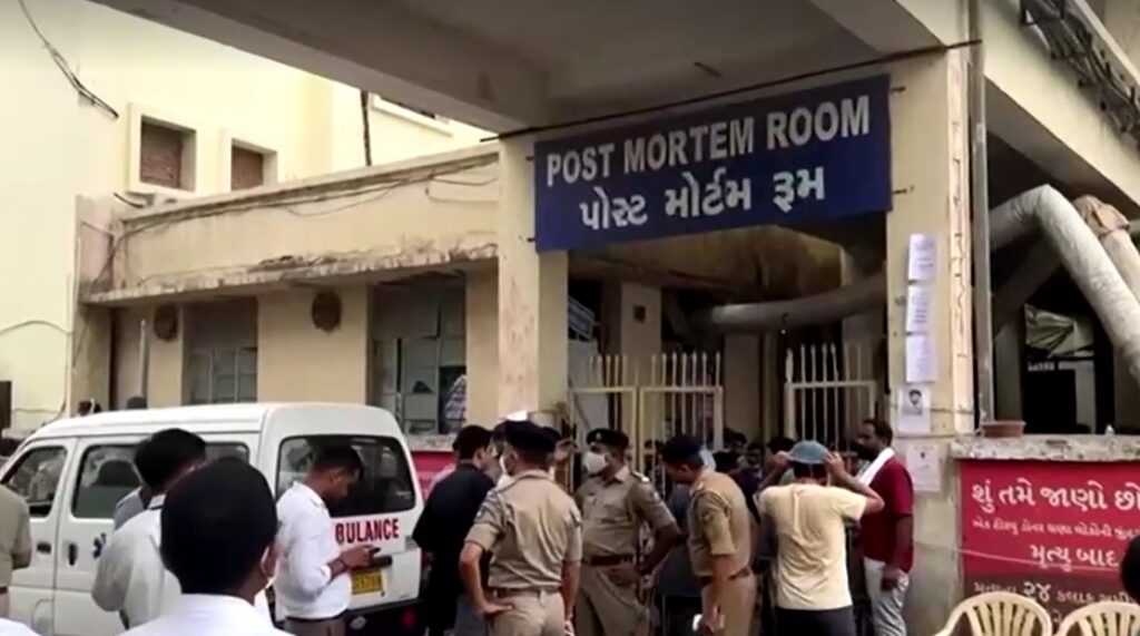 crowd in front of post mortem room in India after Air India crashed