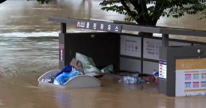 bus stop sinks in South Korea flooded road