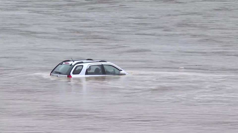 car sinks in South Korea flooded road