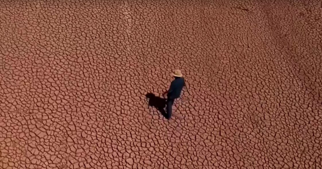 person walks on cracked ground in Mexico Jun 2024