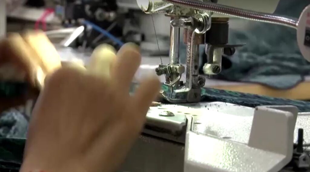 hands of worker working on garment