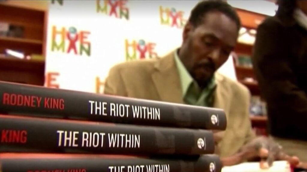 Rodney King signs on his books