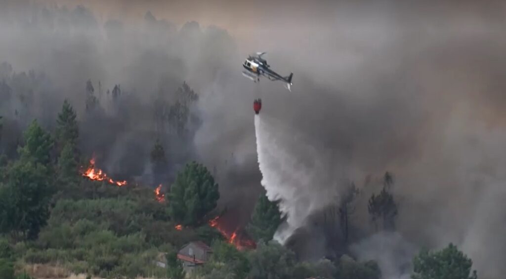 Helicopter unloads water over wildfire in Portugal