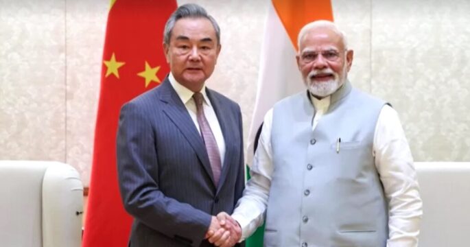 Chinese Foreign Minister Wang Yi shakes hand with Indian Prime Minister Narendra Modi