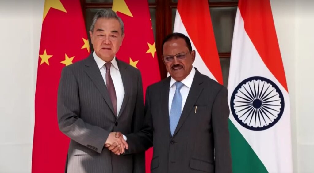 Chinese Foreign Minister Wang Yi shakes hand with Ajit Doval India's national security adviser