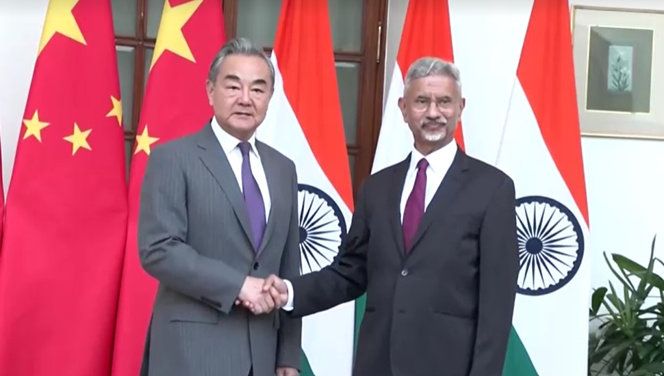 Chinese Foreign Minister Wang Yi shakes hand with Indian counterpart